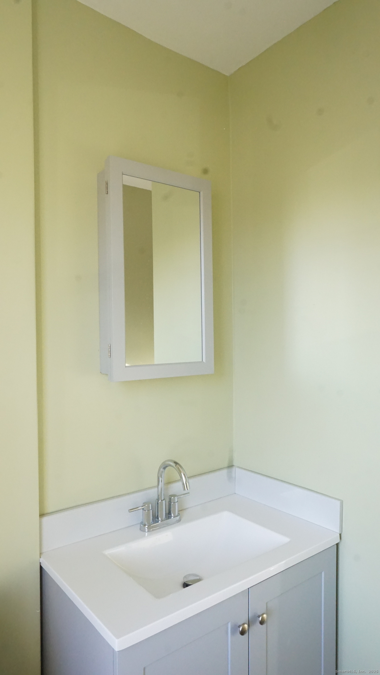 1621 Stratford Avenue, Unit 3 Stratford, CT 06615 - Photo 12 of 17 a bathroom with a sink and a mirror