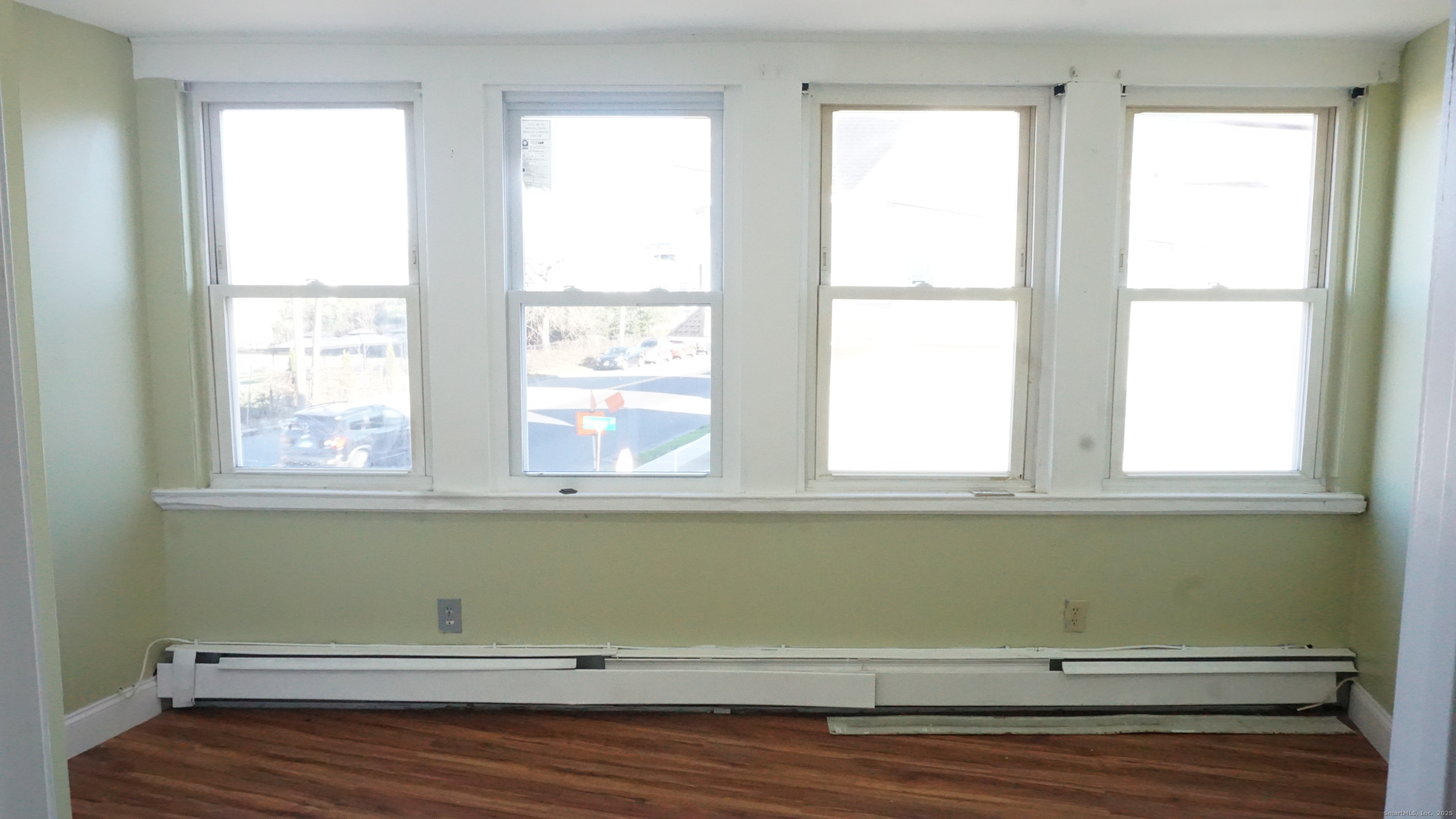 1621 Stratford Avenue, Unit 3 Stratford, CT 06615 - Photo 15 of 17 a view of a room with wooden floor and windows