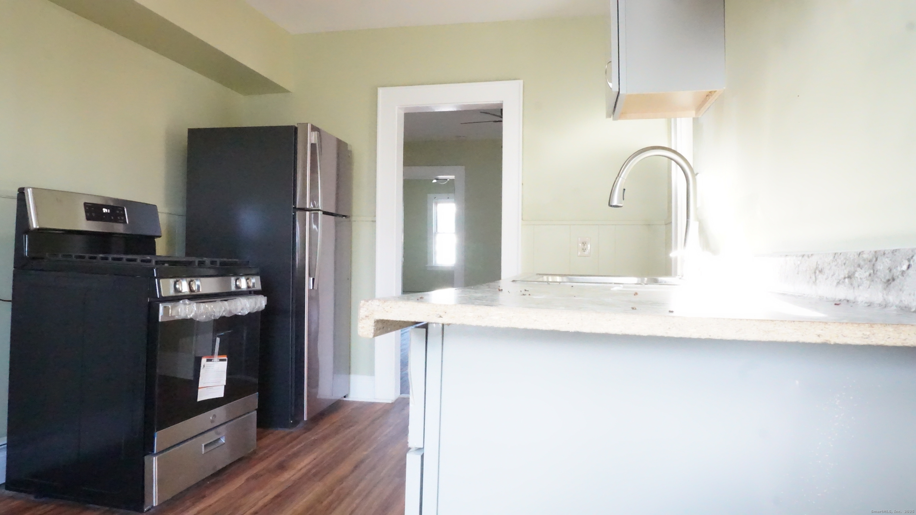 1621 Stratford Avenue, Unit 3 Stratford, CT 06615 - Photo 5 of 17 a kitchen with stainless steel appliances granite countertop a refrigerator and a sink