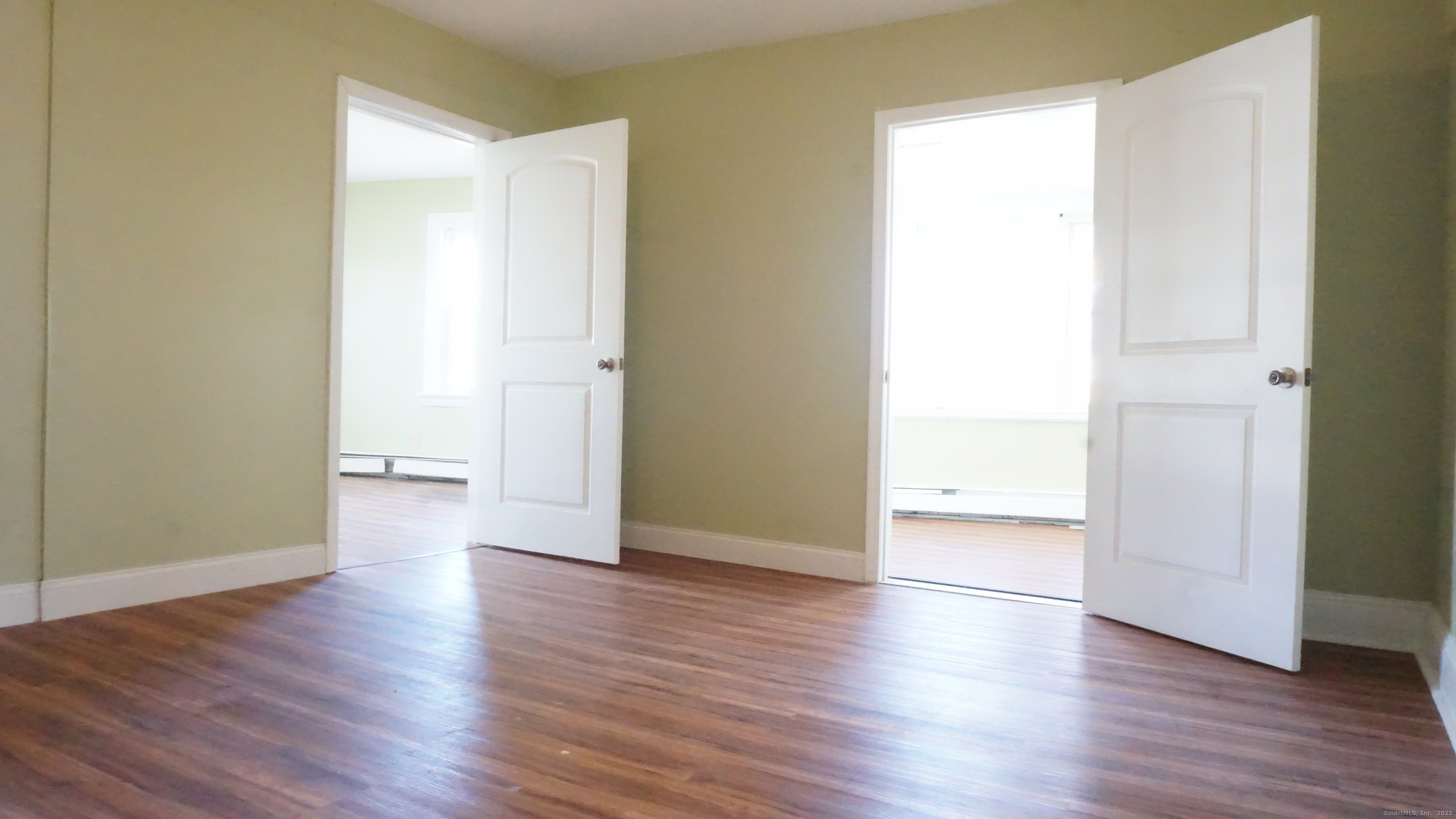 1621 Stratford Avenue, Unit 3 Stratford, CT 06615 - Photo 6 of 17 an empty room with wooden floor