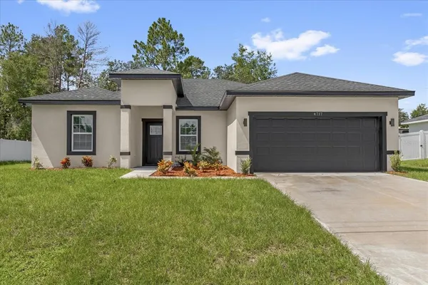 a view of a house with a yard and garage