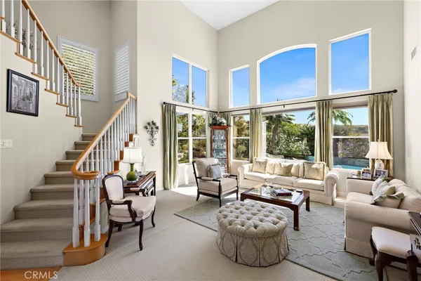 a living room with furniture wooden floor and a large window