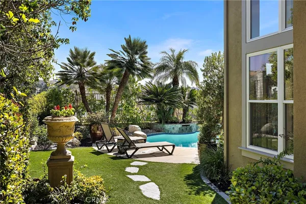 a view of a backyard with plants and patio