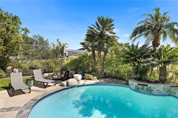 a view of a swimming pool and lounge chairs