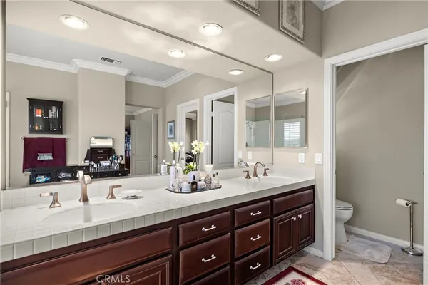 a bathroom with a tub sink double vanity and mirror