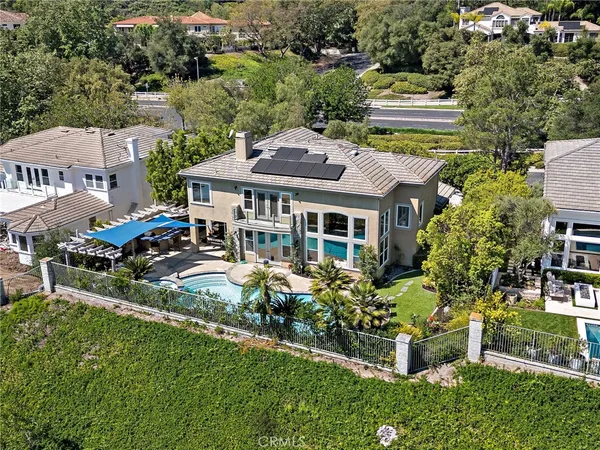 an aerial view of a house with a yard