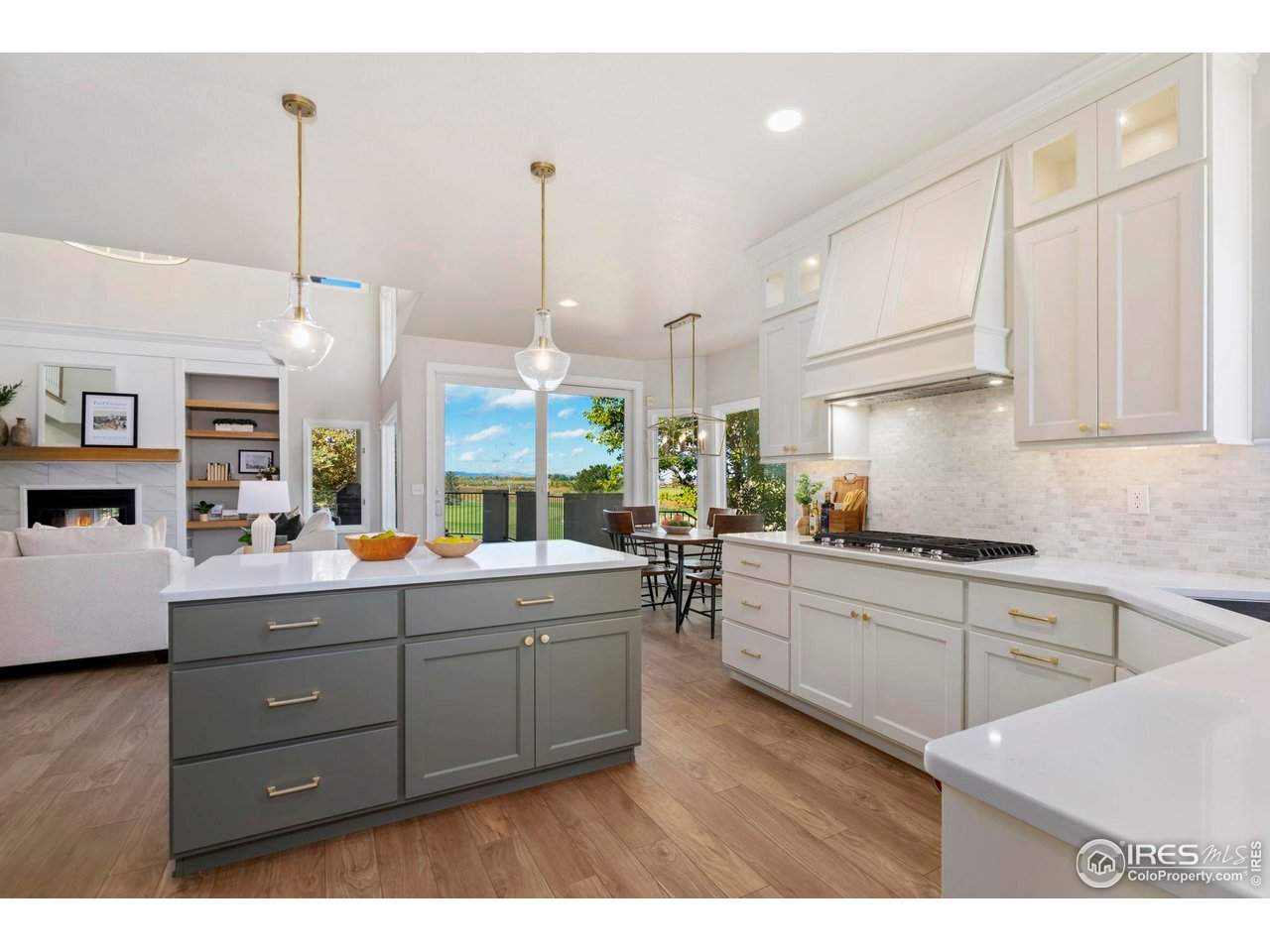 5256 Augusta Trail Fort Collins, CO 80528 - Photo 14 of 50 a kitchen with stainless steel appliances kitchen island granite countertop a sink a stove and a wooden floors