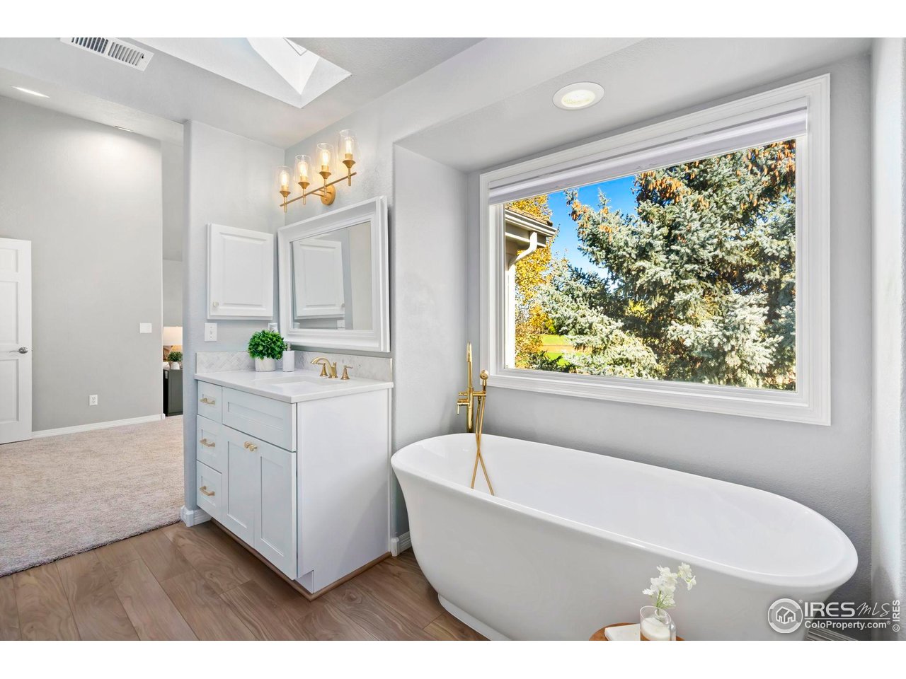 5256 Augusta Trail Fort Collins, CO 80528 - Photo 31 of 50 a bathroom with a bathtub a sink and a window
