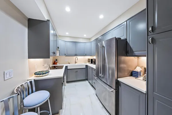 a living room with furniture and kitchen view