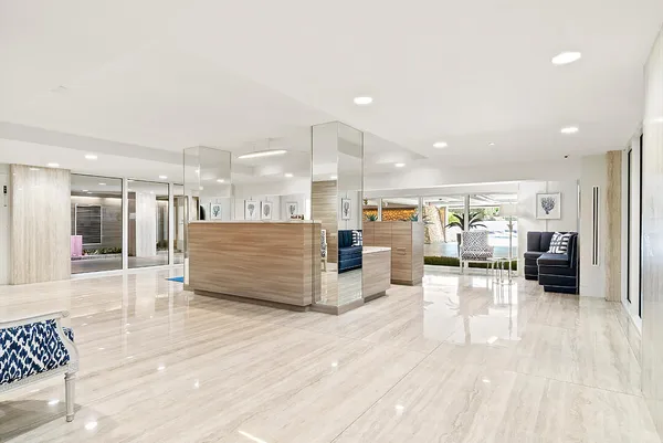a view of a patio with a table and chairs under an umbrella