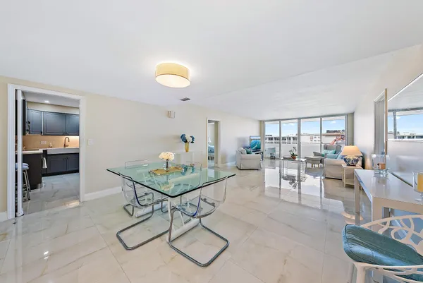 a living room with furniture and a view of kitchen