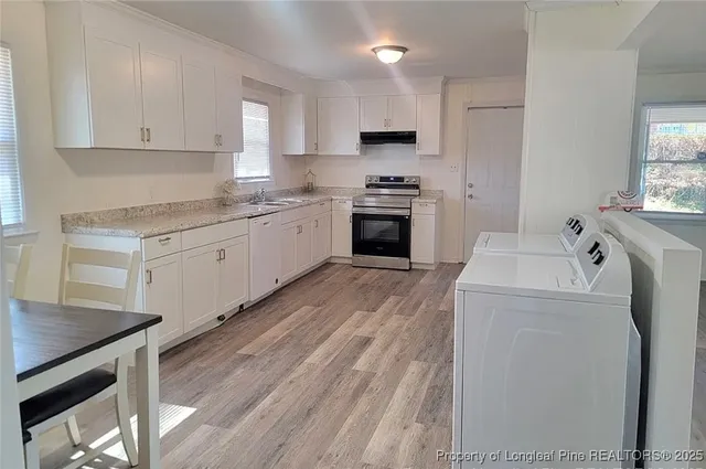 a kitchen with a stove a sink and a refrigerator
