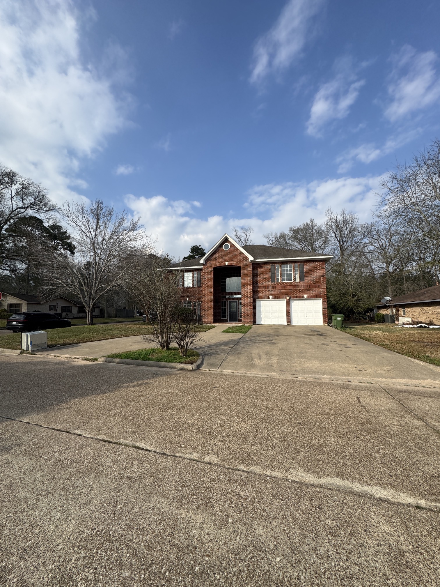 201 Pebble Springs Lane Cleveland, TX 77327 - Photo 1 of 27 a front view of a house with a yard and garage