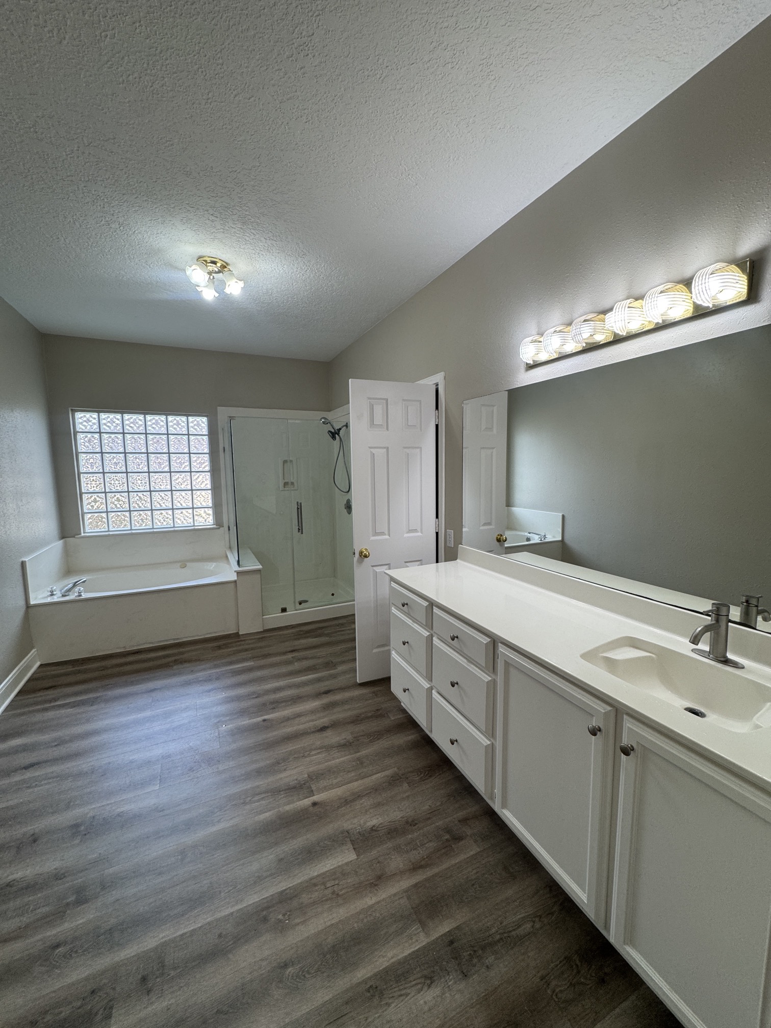 201 Pebble Springs Lane Cleveland, TX 77327 - Photo 16 of 27 a spacious bathroom with double vanity and a mirror