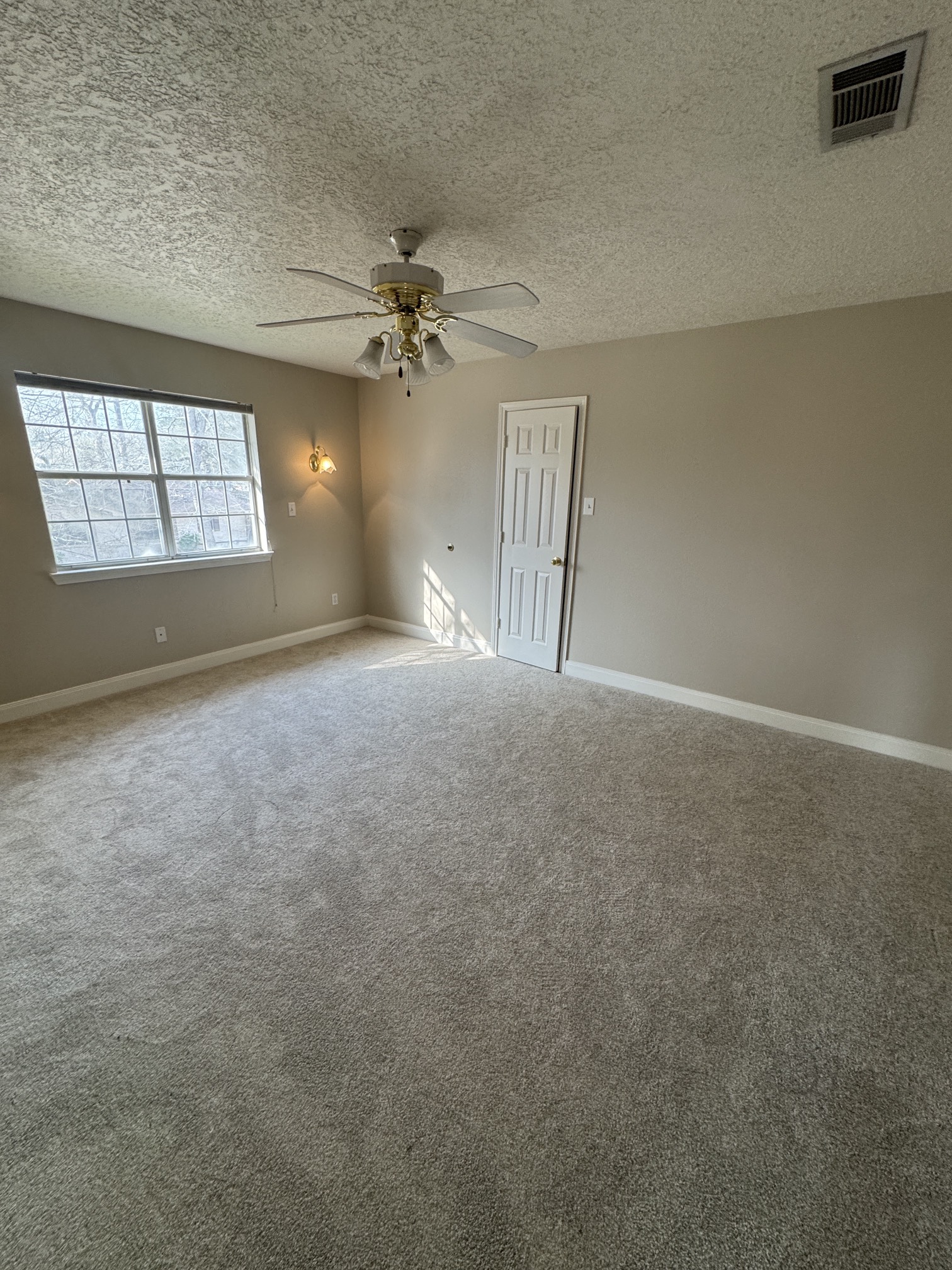 201 Pebble Springs Lane Cleveland, TX 77327 - Photo 23 of 27 en empty room with windows and ceiling fan view