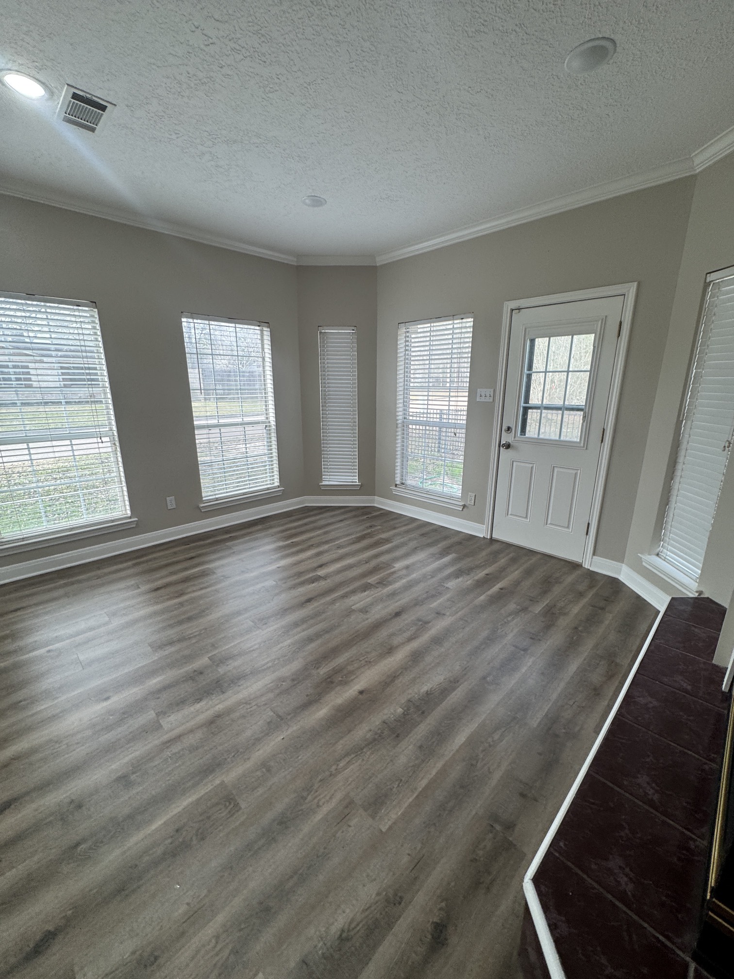 201 Pebble Springs Lane Cleveland, TX 77327 - Photo 27 of 27 an empty room with wooden floor and windows