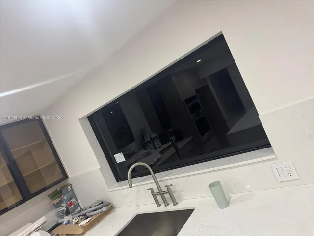 a large kitchen with a large counter top stainless steel appliances and cabinets