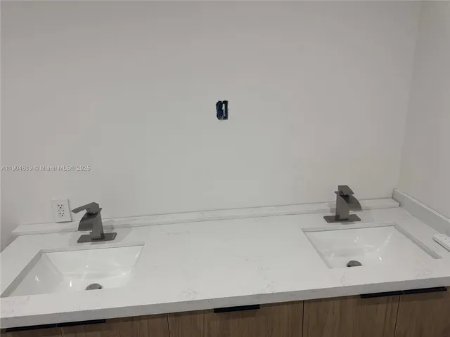 an empty room with furniture and a flat screen tv