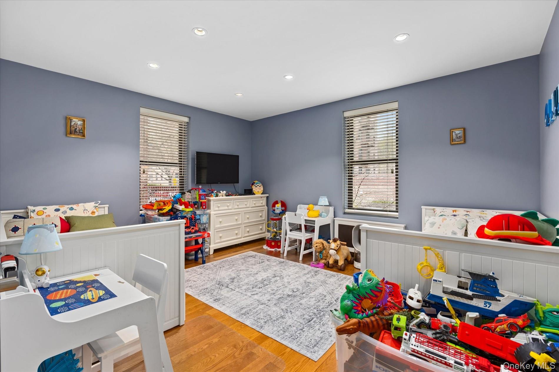 83-30 98th Street, Unit 1H Queens, NY 11421 - Photo 12 of 18 a very nice looking room with a baby crib furniture and a flat screen tv
