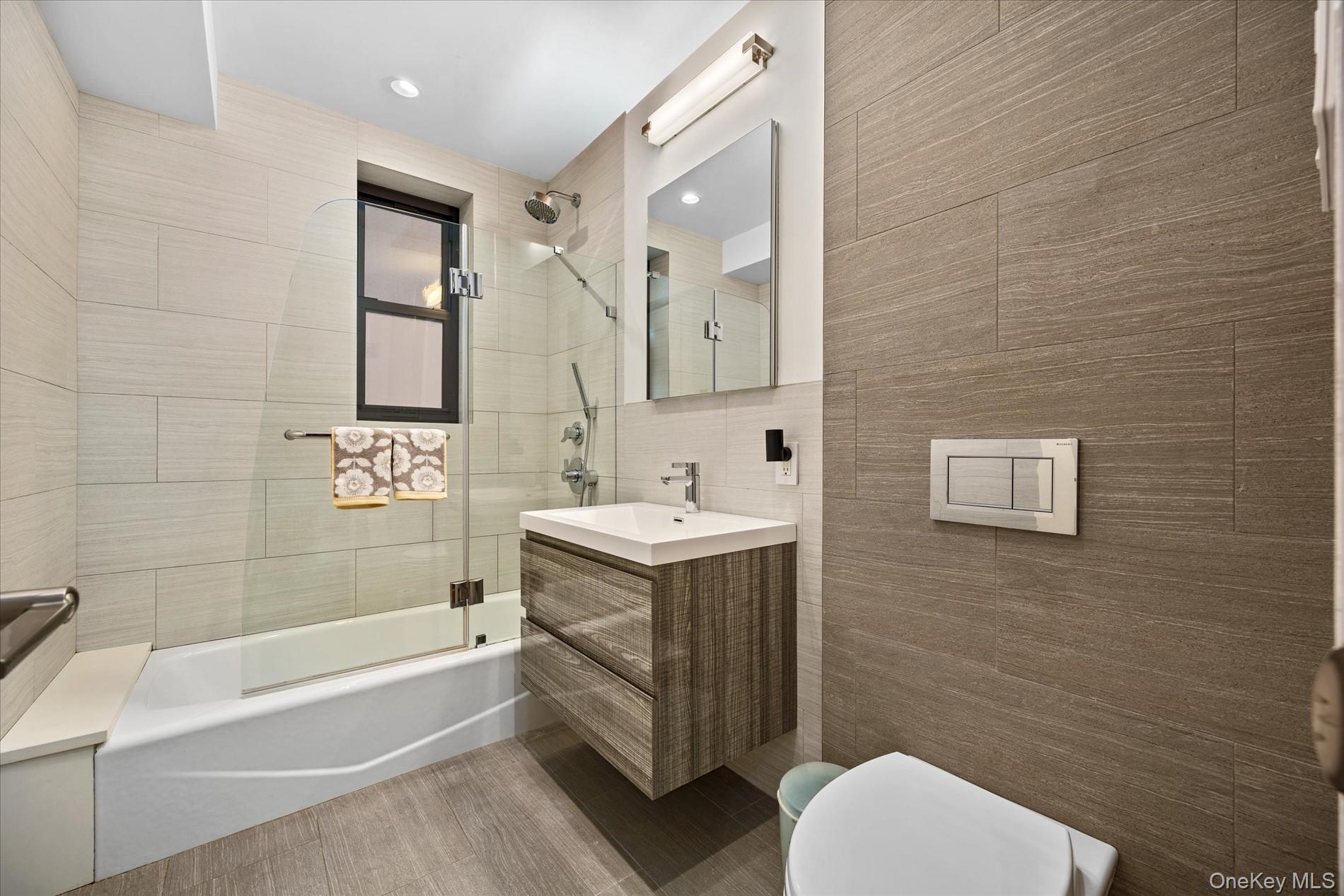 83-30 98th Street, Unit 1H Queens, NY 11421 - Photo 14 of 18 a bathroom with a sink toilet and bathtub