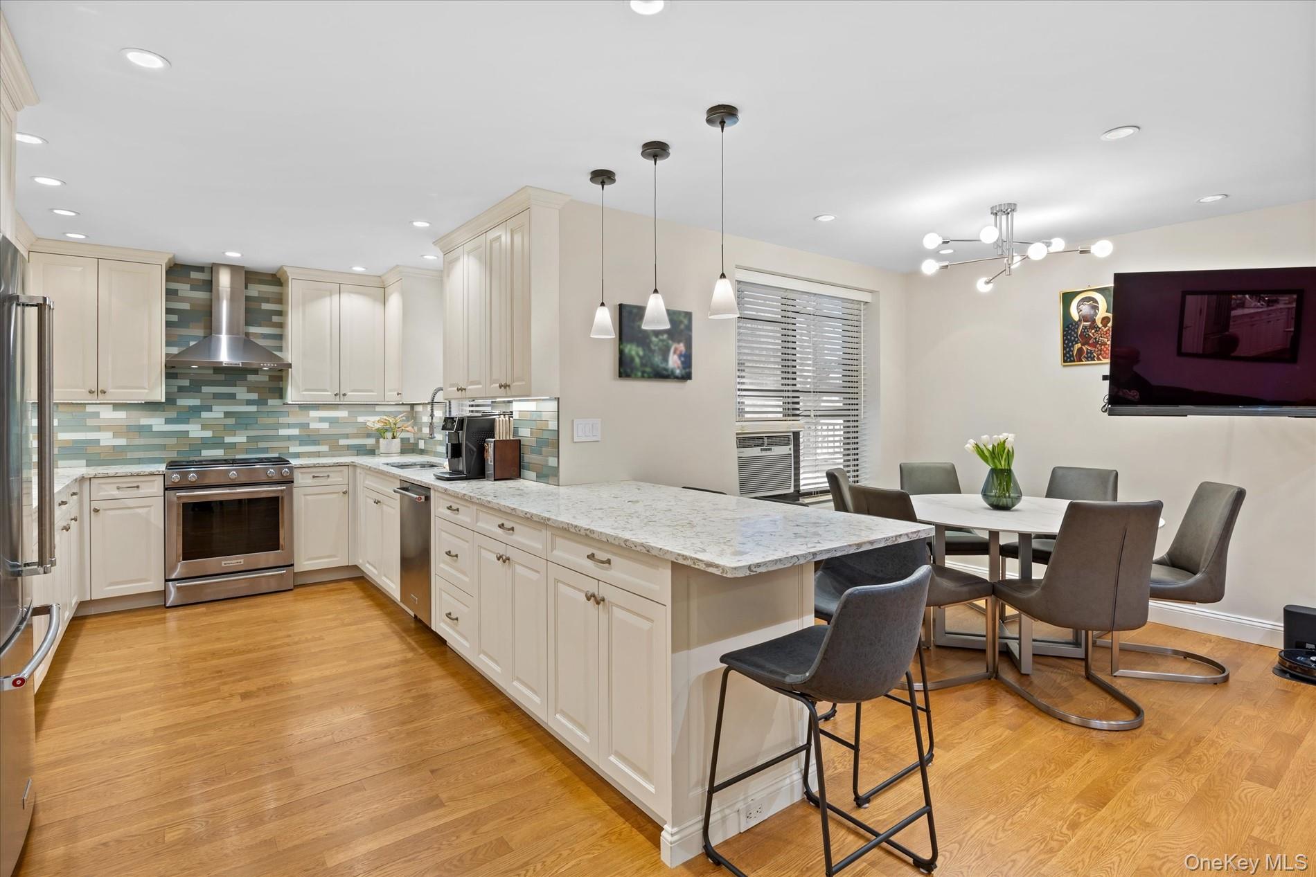 83-30 98th Street, Unit 1H Queens, NY 11421 - Photo 4 of 18 a kitchen with stainless steel appliances kitchen island granite countertop a stove a sink and a refrigerator
