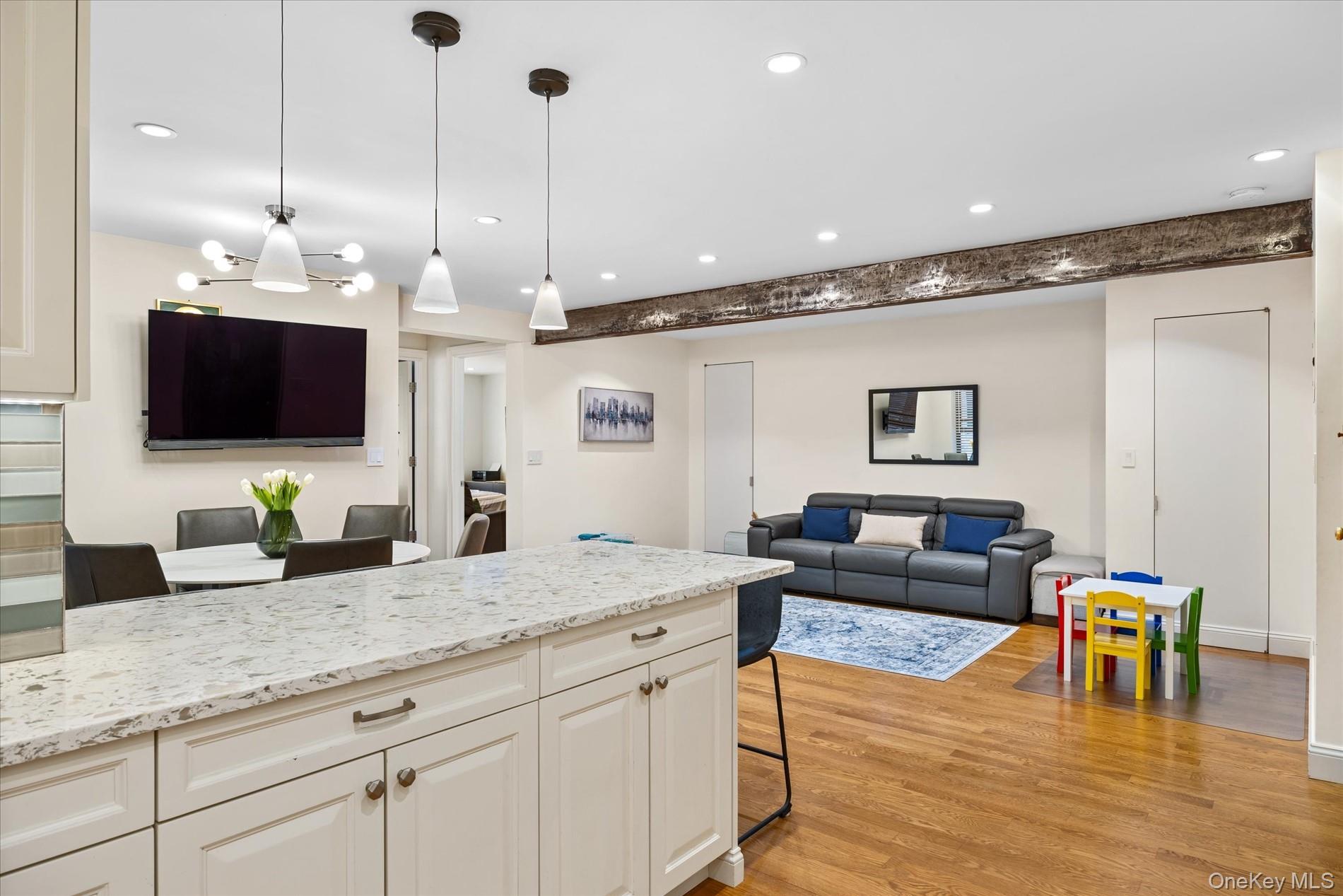83-30 98th Street, Unit 1H Queens, NY 11421 - Photo 5 of 18 a open kitchen with stainless steel appliances granite countertop a sink a stove and a wooden floors