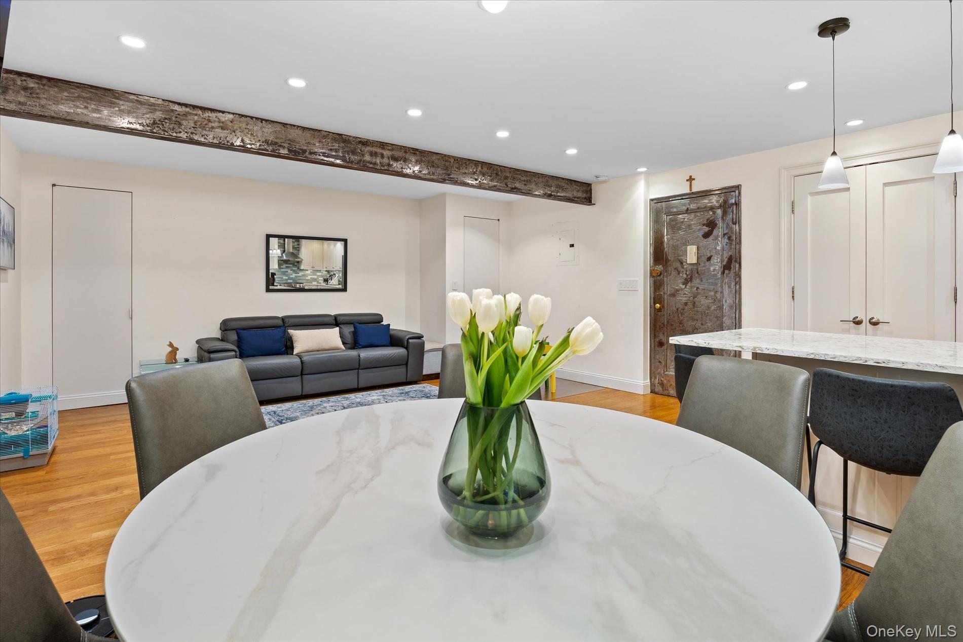 83-30 98th Street, Unit 1H Queens, NY 11421 - Photo 9 of 18 a living room with furniture potted plant and a chandelier