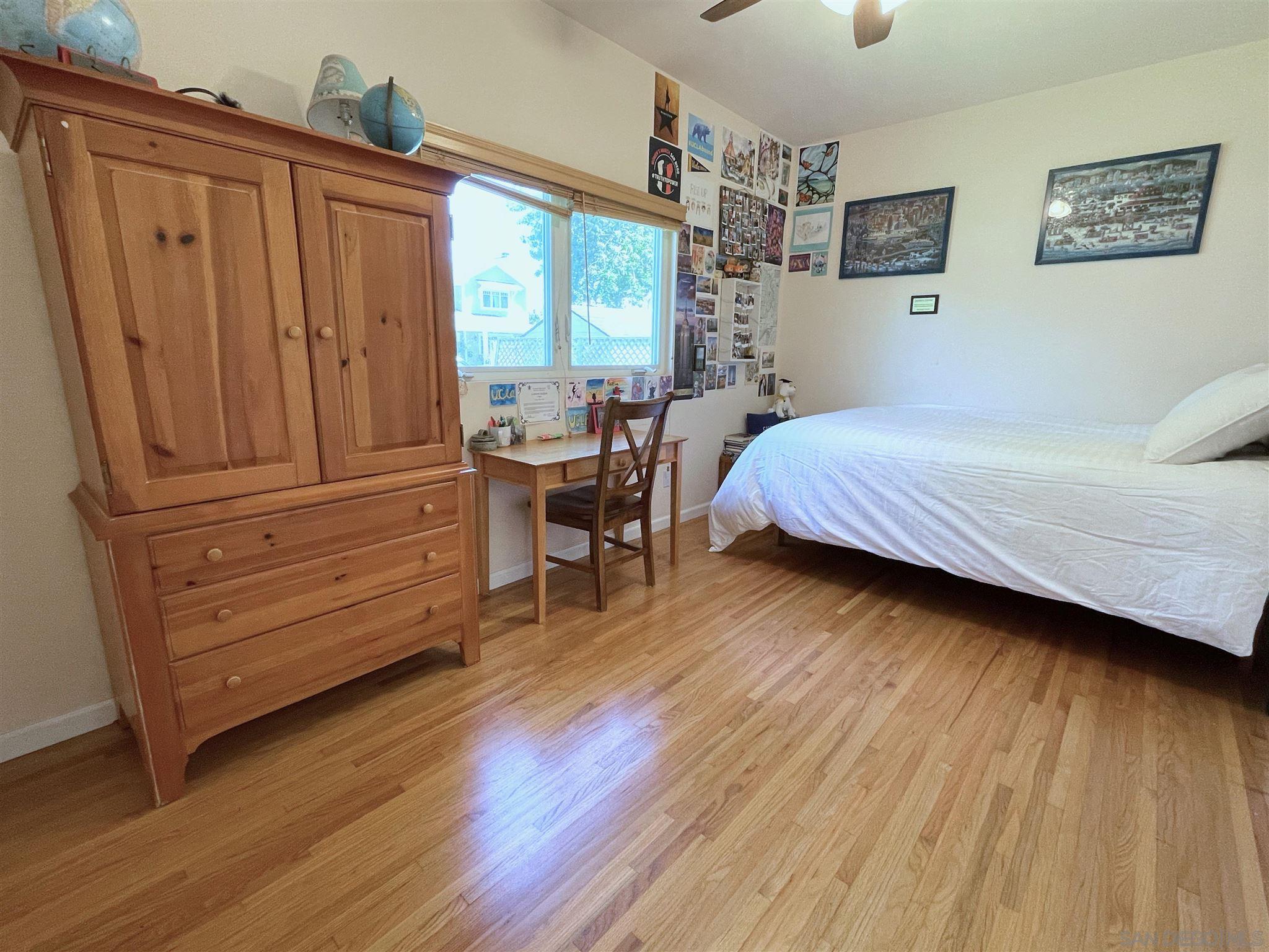 950 Cabrillo Avenue Coronado, CA 92118 - Photo 23 of 31 a bedroom with a bed and wooden floor