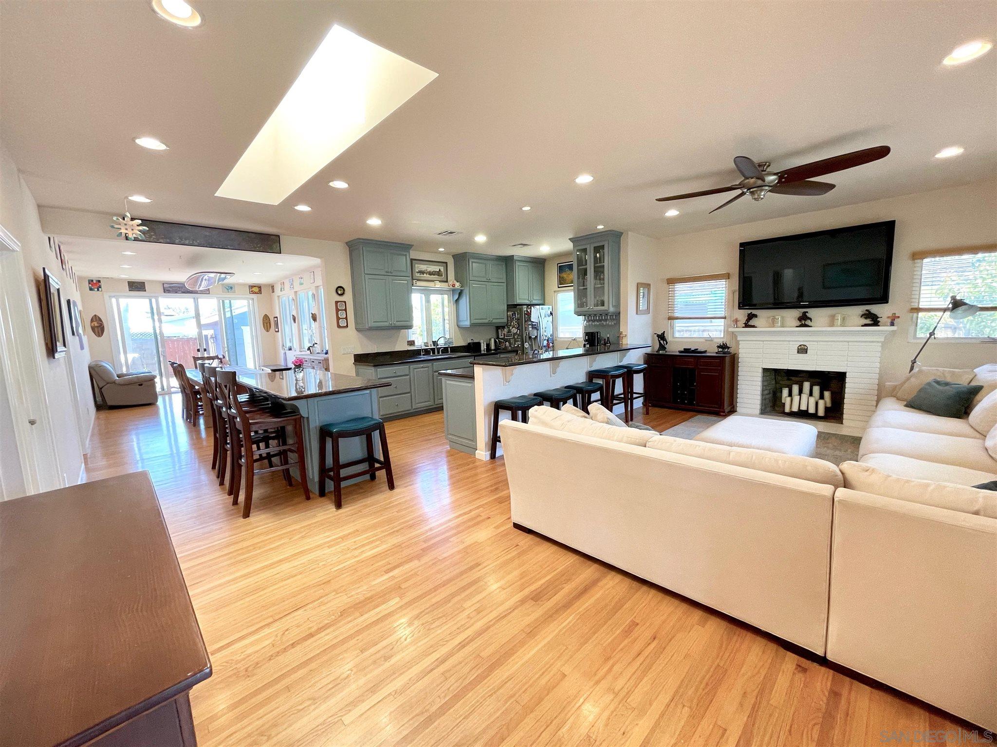 950 Cabrillo Avenue Coronado, CA 92118 - Photo 5 of 31 a living room with stainless steel appliances furniture a flat screen tv and a refrigerator
