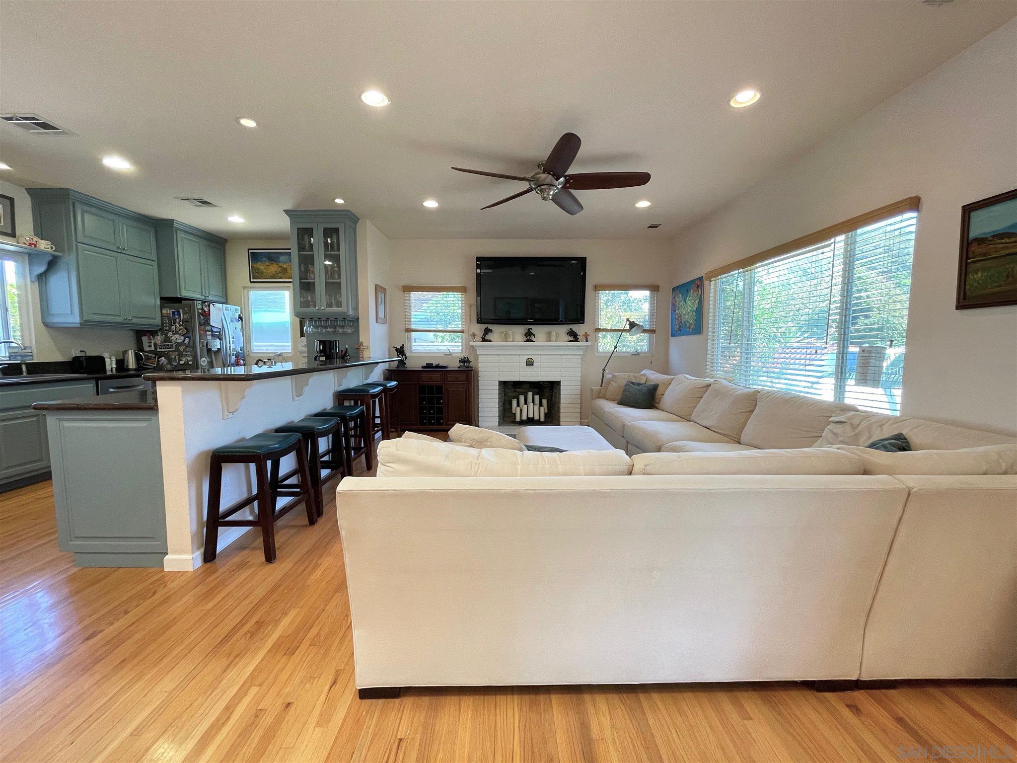 950 Cabrillo Avenue Coronado, CA 92118 - Photo 6 of 31 a large kitchen with kitchen island a stove a sink a dining table and chairs