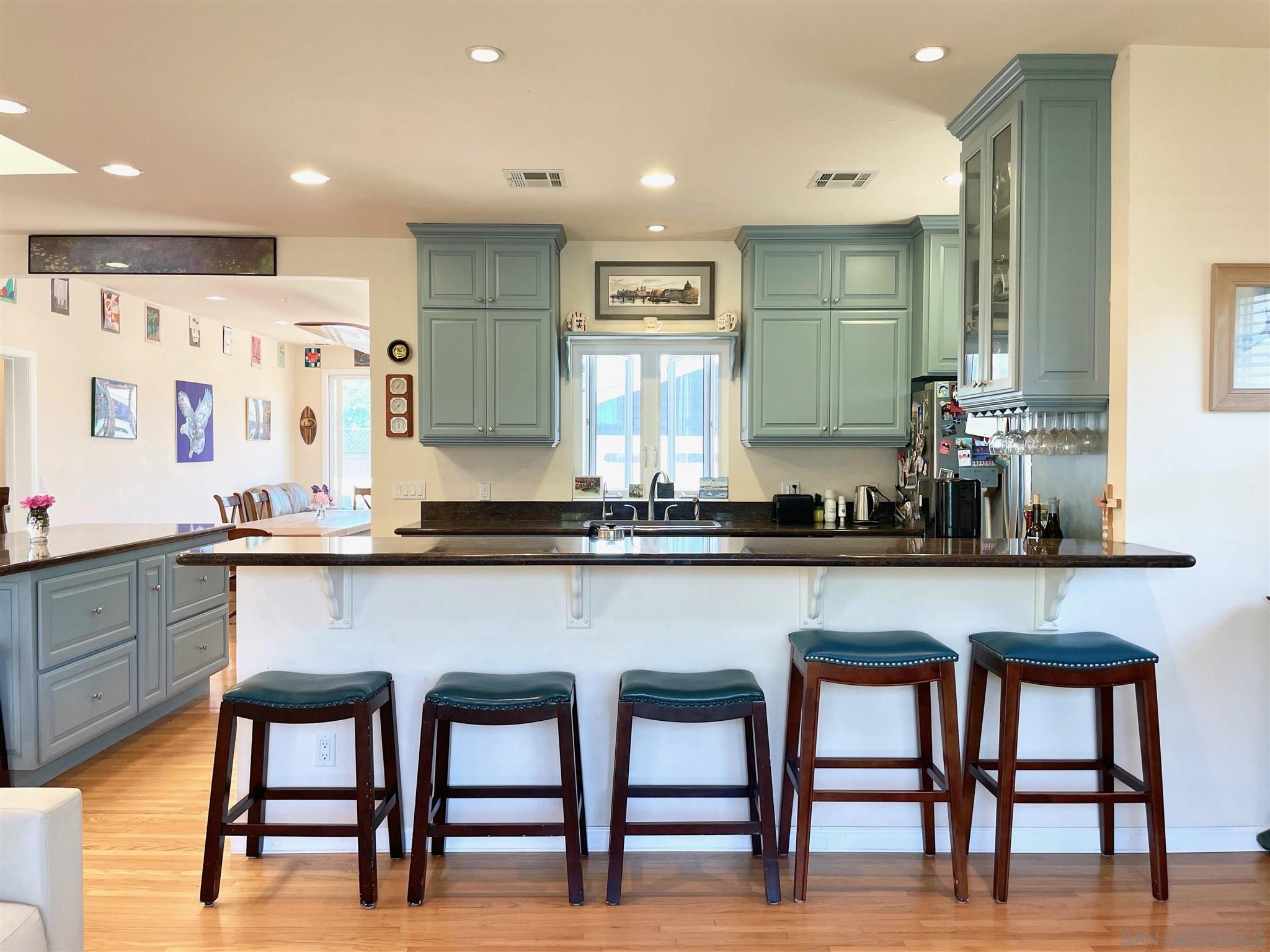 950 Cabrillo Avenue Coronado, CA 92118 - Photo 9 of 31 a kitchen with a table chairs sink and cabinets