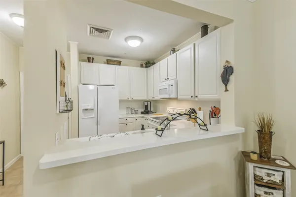 a kitchen with stainless steel appliances a sink a stove and a refrigerator