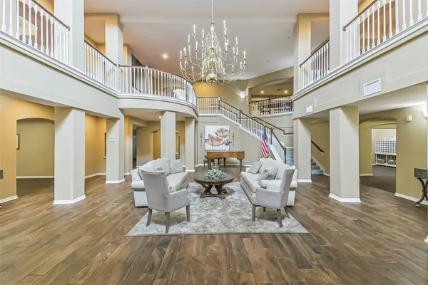 a dining room with wooden floor and chandelier