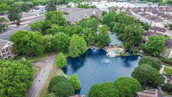 an aerial view of a house with yard and outdoor seating