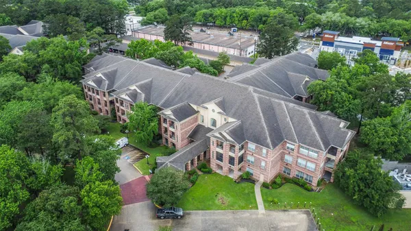 an aerial view of a house with a garden and a yard