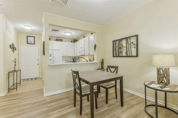 a view of a dining room with furniture and wooden floor