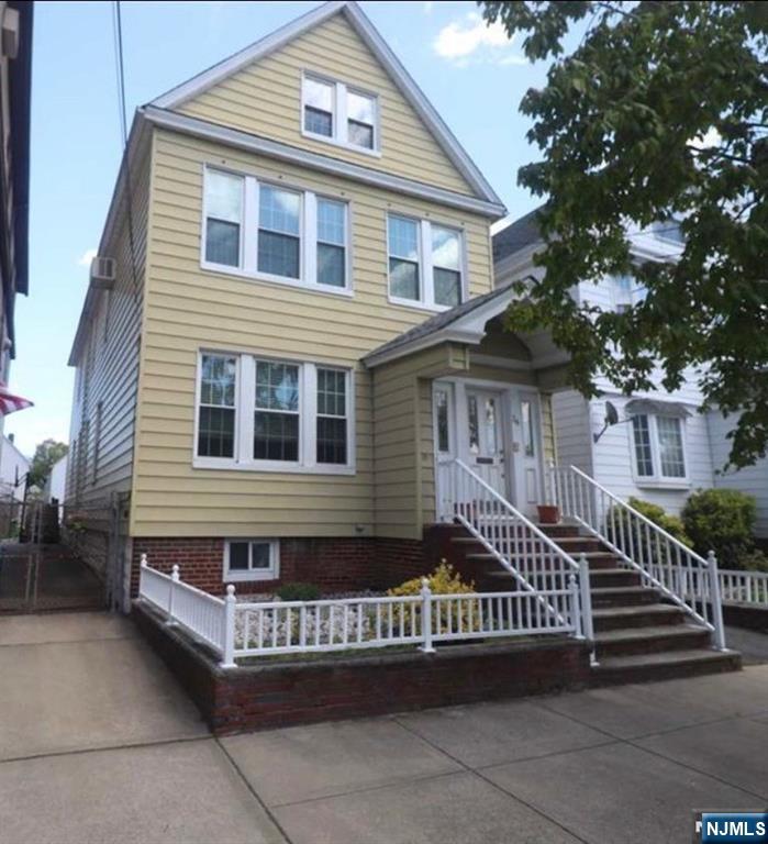 34 Garretson Avenue, Unit 2 Bayonne, NJ 07002 - Photo 1 of 12 a front view of a house with a garage