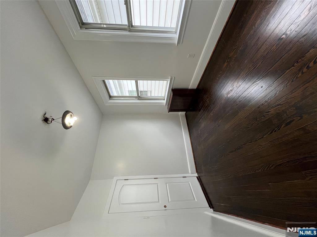 34 Garretson Avenue, Unit 2 Bayonne, NJ 07002 - Photo 11 of 12 an empty room with wooden floor and windows