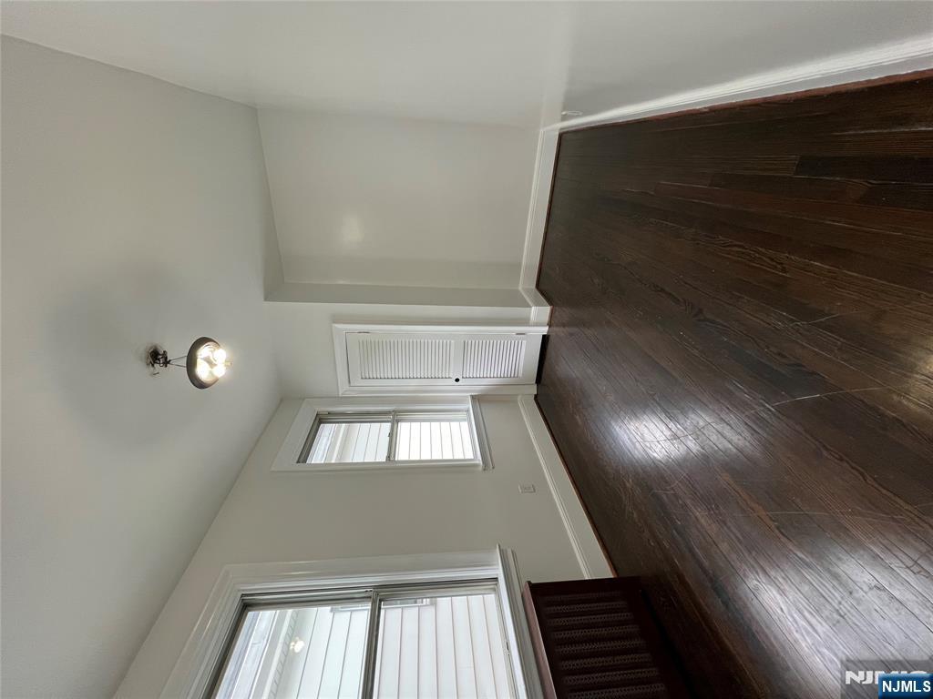 34 Garretson Avenue, Unit 2 Bayonne, NJ 07002 - Photo 12 of 12 an empty room with wooden floor and windows