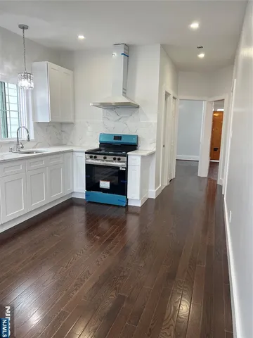 a kitchen with granite countertop a stove and a refrigerator
