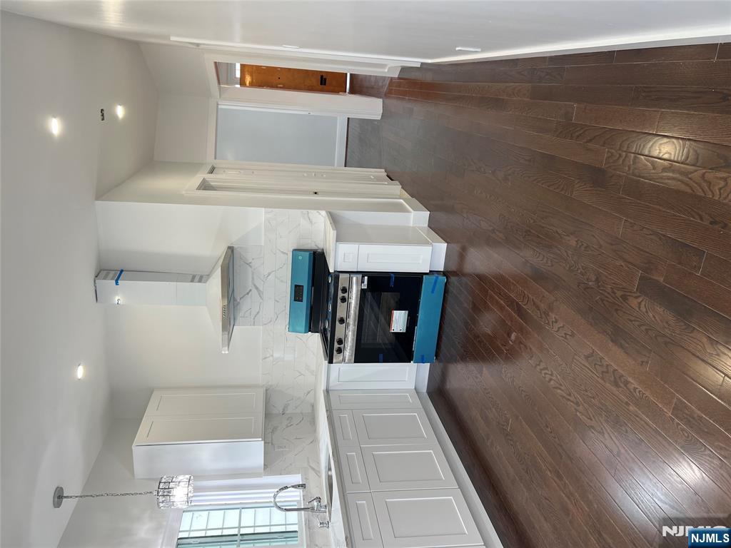 34 Garretson Avenue, Unit 2 Bayonne, NJ 07002 - Photo 4 of 12 a kitchen with granite countertop a stove and a refrigerator