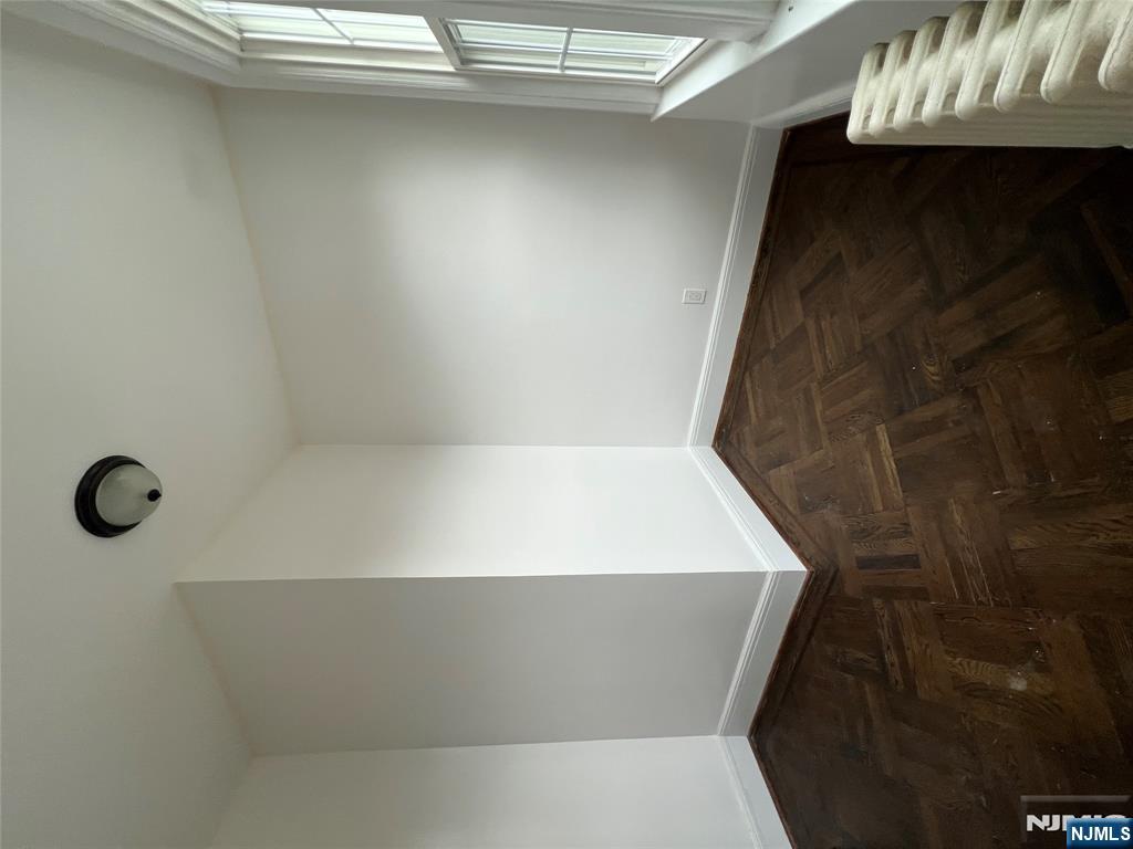 34 Garretson Avenue, Unit 2 Bayonne, NJ 07002 - Photo 8 of 12 an empty room with wooden floor and windows