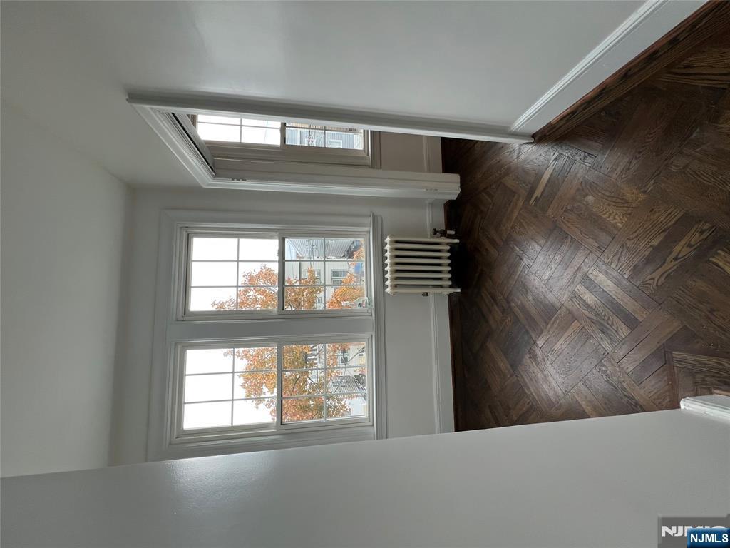 34 Garretson Avenue, Unit 2 Bayonne, NJ 07002 - Photo 10 of 12 an empty room with windows