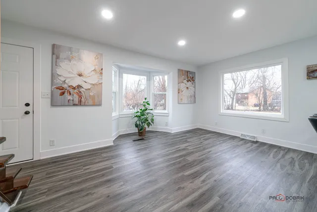 a view of an hallway with wooden floor and a potted plant