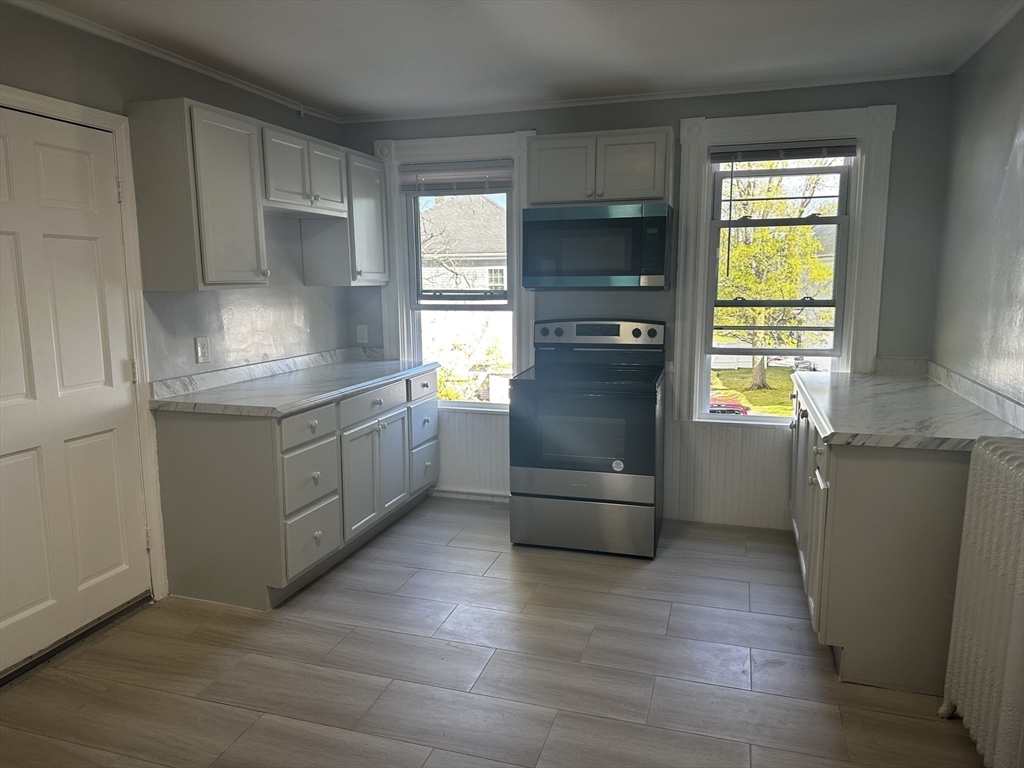 4 Howard Avenue, Unit 2 Attleboro, MA 02703 - Photo 1 of 17 a kitchen with stainless steel appliances a refrigerator and a stove