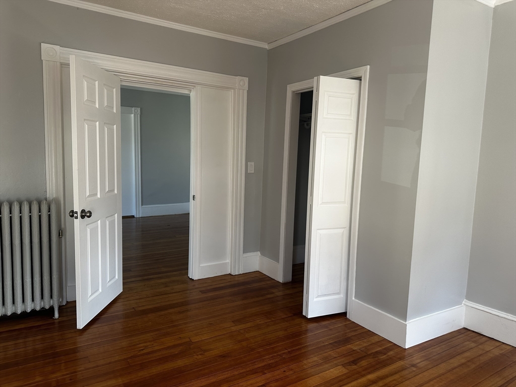 4 Howard Avenue, Unit 2 Attleboro, MA 02703 - Photo 12 of 17 an empty room with wooden floor and closet