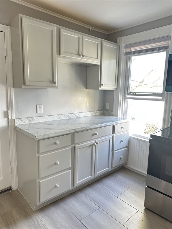4 Howard Avenue, Unit 2 Attleboro, MA 02703 - Photo 2 of 17 a kitchen with granite countertop white cabinets and sink
