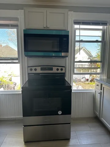 a kitchen with a stove and a microwave