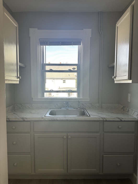 4 Howard Avenue, Unit 2 Attleboro, MA 02703 - Photo 6 of 17 a bathroom with a granite countertop sink and a window