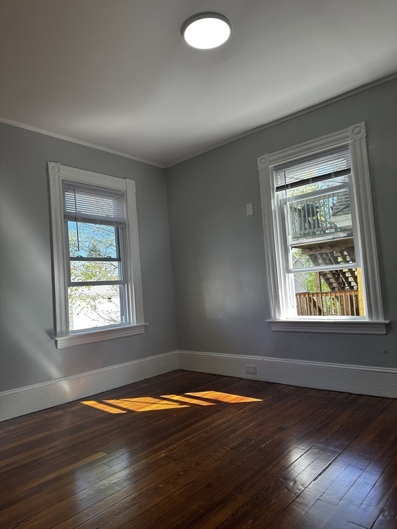 4 Howard Avenue, Unit 2 Attleboro, MA 02703 - Photo 7 of 17 an empty room with wooden floor and windows